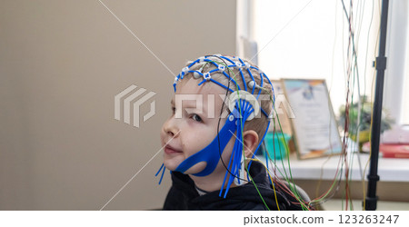 A boy's brain is examined on an EEG machine. Electroencephalogram is performed in a hospital laboratory to detect neurological diseases. Encephalogram for children 123263247