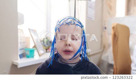 A boy's brain is examined on an EEG machine. Electroencephalogram is performed in a hospital laboratory to detect neurological diseases. Encephalogram for children A boy's brain is examined on an EEG machine. Electroencephalogram is performed in a hospital laboratory to detect neurological diseases. Encephalogram for children 123263322
