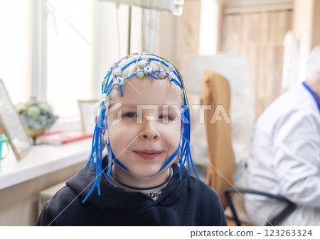 A boy's brain is examined on an EEG machine. Electroencephalogram is performed in a hospital laboratory to detect neurological diseases. Encephalogram for children A boy's brain is examined on an EEG machine. Electroencephalogram is performed in a hospital laboratory to detect neurological diseases. Encephalogram for children 123263324