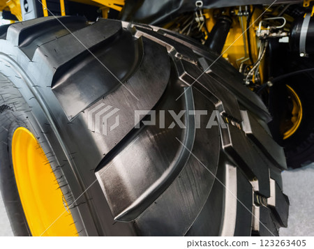 Heavy-duty tractor tire showcasing engineering and design in agricultural machinery 123263405