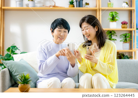 Two senior women looking at a smartphone Two senior women looking at a smartphone 123264445
