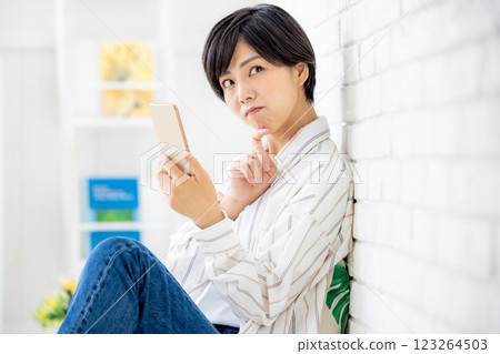 Woman operating a smartphone Woman operating a smartphone 123264503