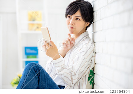Woman operating a smartphone Woman operating a smartphone 123264504