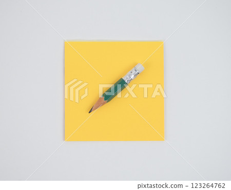 composition of yellow note and green pencil isolated on white composition of yellow note and green pencil isolated on white 123264762