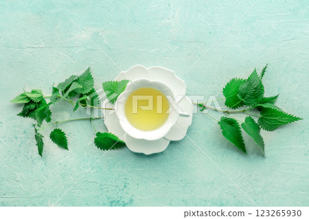 Nettle tea. Medicinal herbal tea with Urtica leaves. Fresh wild herb 123265930