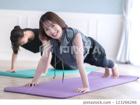 Two young women doing muscle training 123266266
