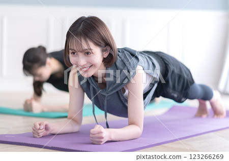 Two young women doing muscle training 123266269