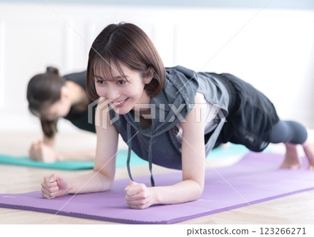 Two young women doing muscle training 123266271