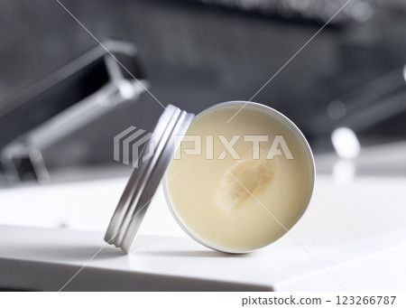 Opened body butter jar modern faucet on basin in dark grey bathroom close up, cosmetic mockup 123266787