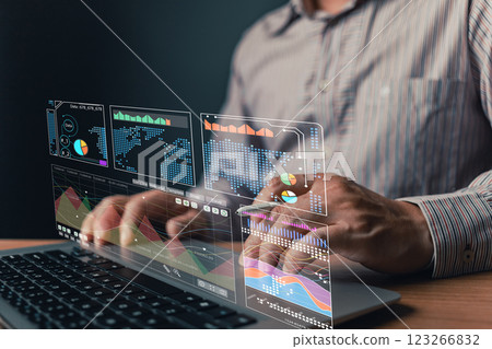 man use laptop with growth graphs and progress of business and analyze finance, and investment.Use technology to plan strategy to success goals and growth stock.online business, online marketing. 123266832