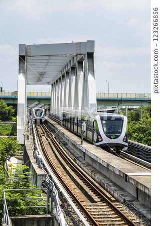 A Green Line train running on the elevated track of the Taichung Rapid Transit System in Taiwan.  123266856