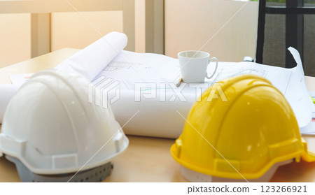 Hard safety helmet hats, construction equipment, blueprint on the table in conference office worker, architect working desk. Engineering tools concept. 123266921