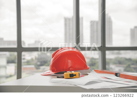 Hard safety helmet hats, construction equipment, blueprint on the table in conference office worker, architect working desk. Engineering tools concept. 123266922