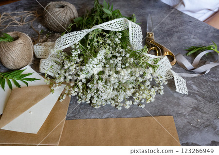 Crafting with natural elements using freshly picked flowers in a creative workspace 123266949