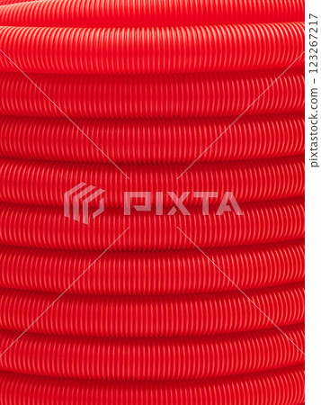Plastic corrugated hose close-up. Red background, texture. Plastic corrugated hose close-up. Red background, texture. 123267217