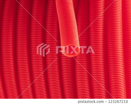Plastic corrugated hose closeup. Red background. Plastic corrugated hose closeup. Red background. 123267218