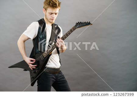 Young man playing electric guitar Young man playing electric guitar 123267399
