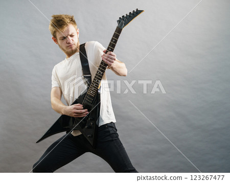 Man playing on electric guitar 123267477