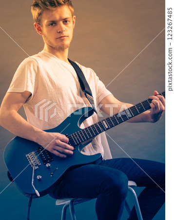 Young man playing electric guitar Young man playing electric guitar 123267485