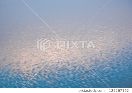 Beautiful sunset over the lake. Sunrise on the sea. Beautiful landscape with lake, mountains and sunset. Reflection in the water	 123267562