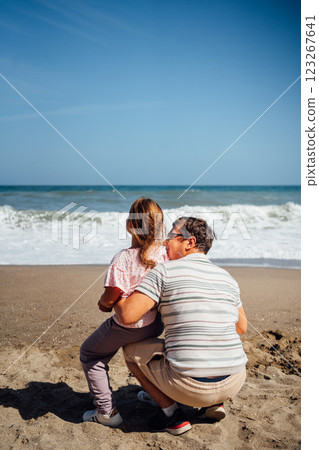 A joyful moment between a father and daughter as they share smiles and laughter while standing on a A joyful moment between a father and daughter as they share smiles and laughter while standing on a 123267641