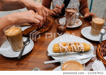 A delicious spread of churros and coffee served at a traditional cafe in Ronda, Spain, showcasing 123267652