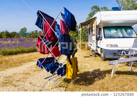 Clothes hanging to dry outdoors by camping car. Caravan vacation. 123267880