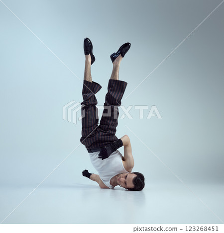 Young man with confident gaze and sculpted physique, exuding fashion energy highlight masculinity against gradient background. Young man with confident gaze and sculpted physique, exuding fashion energy highlight masculinity against gradient background. 123268451