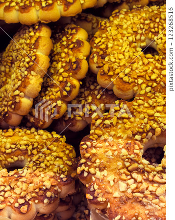 Sweet delights covered in crunchy nuts at a local bakery during morning hours Sweet delights covered in crunchy nuts at a local bakery during morning hours 123268516