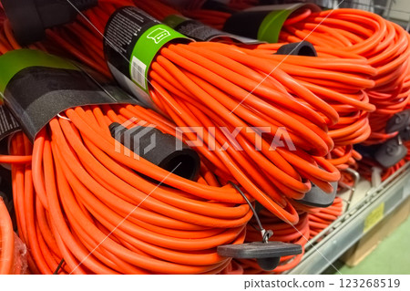 Bright orange extension cords neatly arranged in a hardware store aisle Bright orange extension cords neatly arranged in a hardware store aisle 123268519