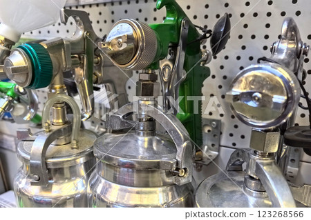 Versatile pneumatic paint sprayers displayed in a workshop setting 123268566