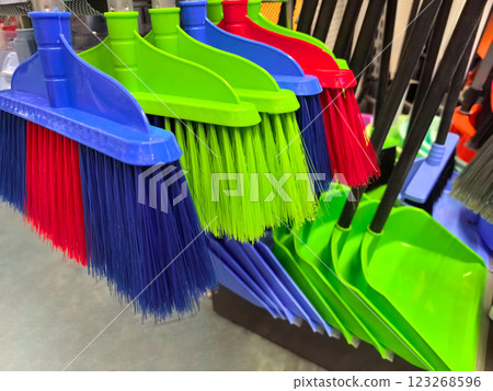 Colorful brooms and dustpans displayed in a vibrant cleaning supplies aisle Colorful brooms and dustpans displayed in a vibrant cleaning supplies aisle 123268596