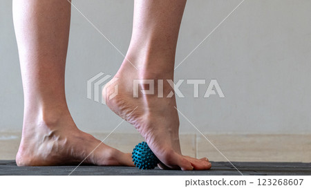 Blue spiky rubber massage ball for recovery massage. MFR ball for rehabilitation and health. Blue spiky rubber massage ball for recovery massage. MFR ball for rehabilitation and health. 123268607