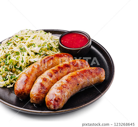 Grilled sausages served with shredded cabbage and dipping sauce Grilled sausages served with shredded cabbage and dipping sauce 123268645