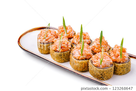 Savory sushi rolls with flavorful toppings arranged elegantly Savory sushi rolls with flavorful toppings arranged elegantly 123268647