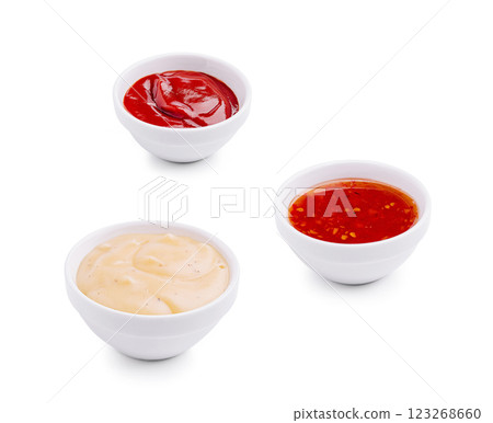 Three dipping sauces in small bowls on a white background Three dipping sauces in small bowls on a white background 123268660