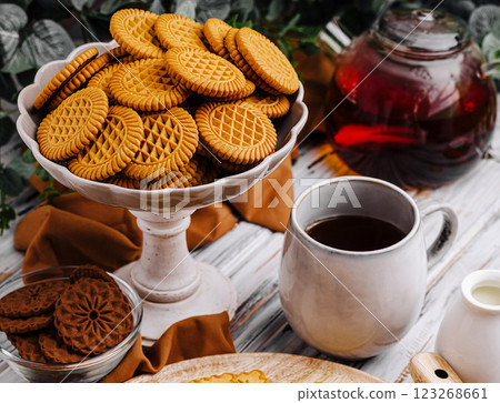 Delicious cookies served with tea and coffee on a cozy table Delicious cookies served with tea and coffee on a cozy table 123268661