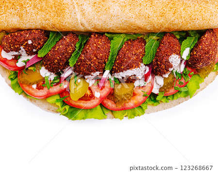 Fresh falafel wrap filled with vibrant vegetables and herbs 123268667