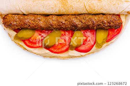 Delicious wrap with grilled meat, tomatoes, and pickles for lunch 123268672