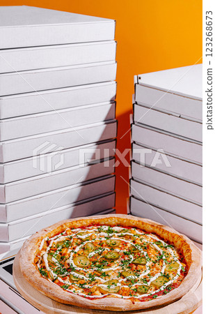Delicious pizza surrounded by pizza boxes against a vibrant backdrop Delicious pizza surrounded by pizza boxes against a vibrant backdrop 123268673