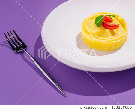 Mashed potato with tomato and basil served on a white plate Mashed potato with tomato and basil served on a white plate 123268690