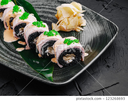 Unique sushi roll presentation with vibrant toppings on a plate 123268693