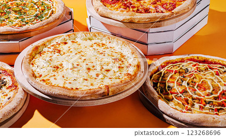 Delicious variety of pizzas displayed on colorful background 123268696