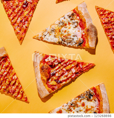 Slices of pizza arranged on a bright yellow background 123268698