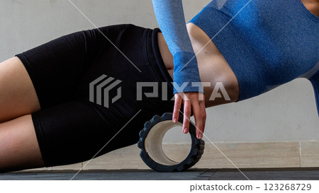Black MFR roller for body. Recovery massage. MFR roll for rehabilitation and health. 123268729