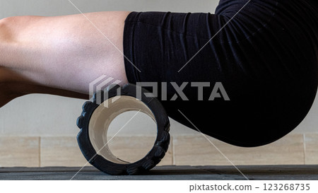 Black MFR roller for body. Recovery massage. MFR roll for rehabilitation and health. 123268735