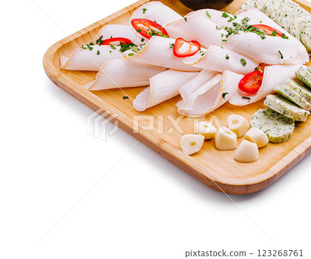 Gourmet platter with cured meats and herbs on a wooden board Gourmet platter with cured meats and herbs on a wooden board 123268761