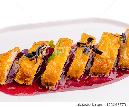 Crispy chicken served with berry sauce on a white plate 123268773