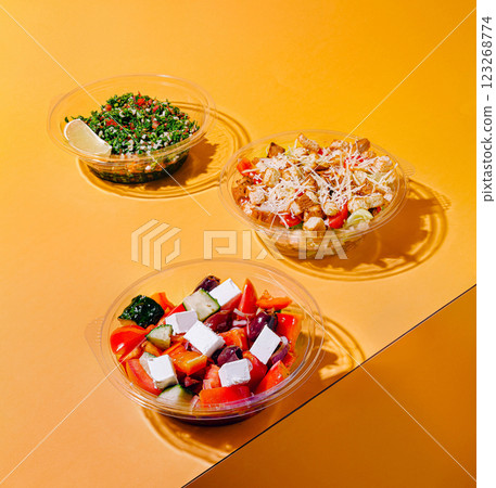 Colorful salads displayed on a bright orange background 123268774