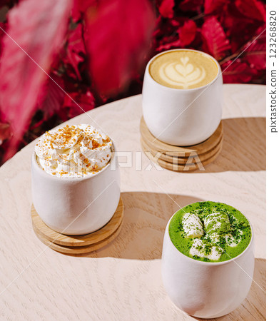 Enjoying seasonal drinks at a cozy cafe with vibrant decor 123268820